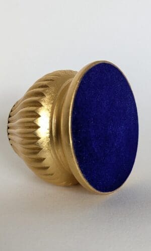 View of the underside of gold candle holder showing blue flocked base