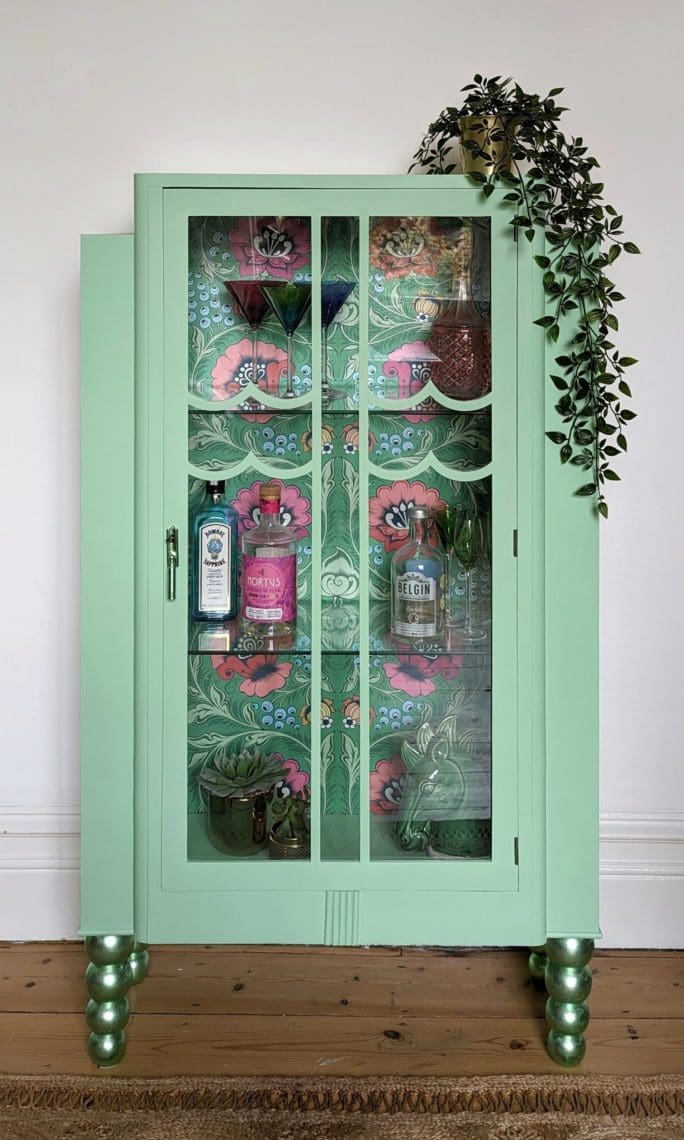 Pistachio Green Glass Display cabinet with green metallic bobbin feet