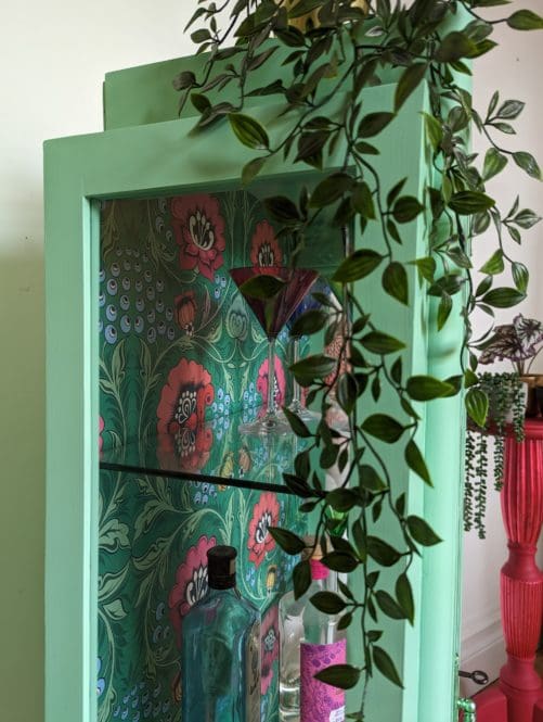 Green painted vintage cabinet with glass side panels