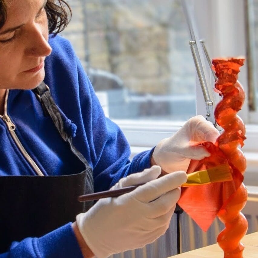 carrie gilding a barley twist candlestick with orange silver leaf