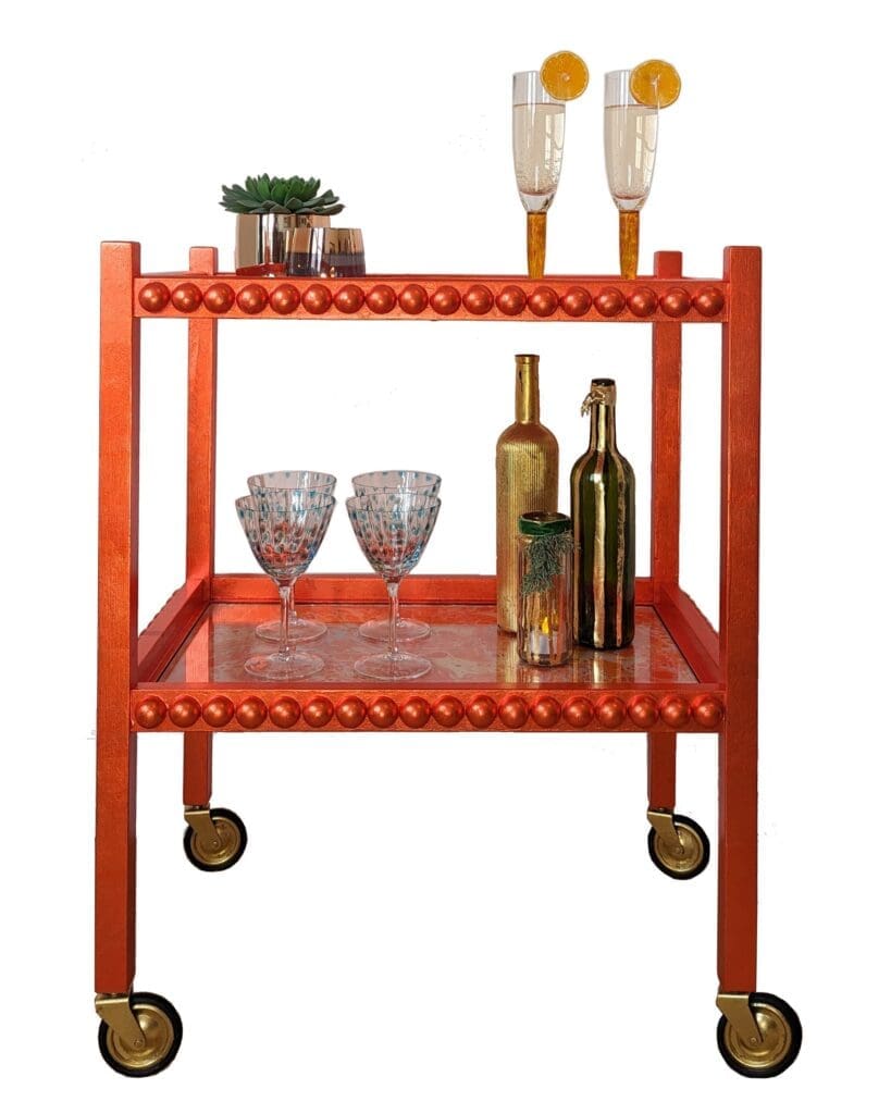 Clementine cutout 45 Vintage drinks trolley named Clementine, finished in orange silver leaf with a mid-century modern design, styled with bottles and glasses