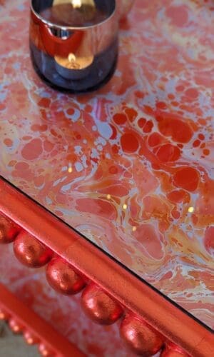 close up of orange marbled surface with orange gilded edge