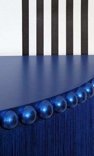 Blue half moon table top with metallic blue trim