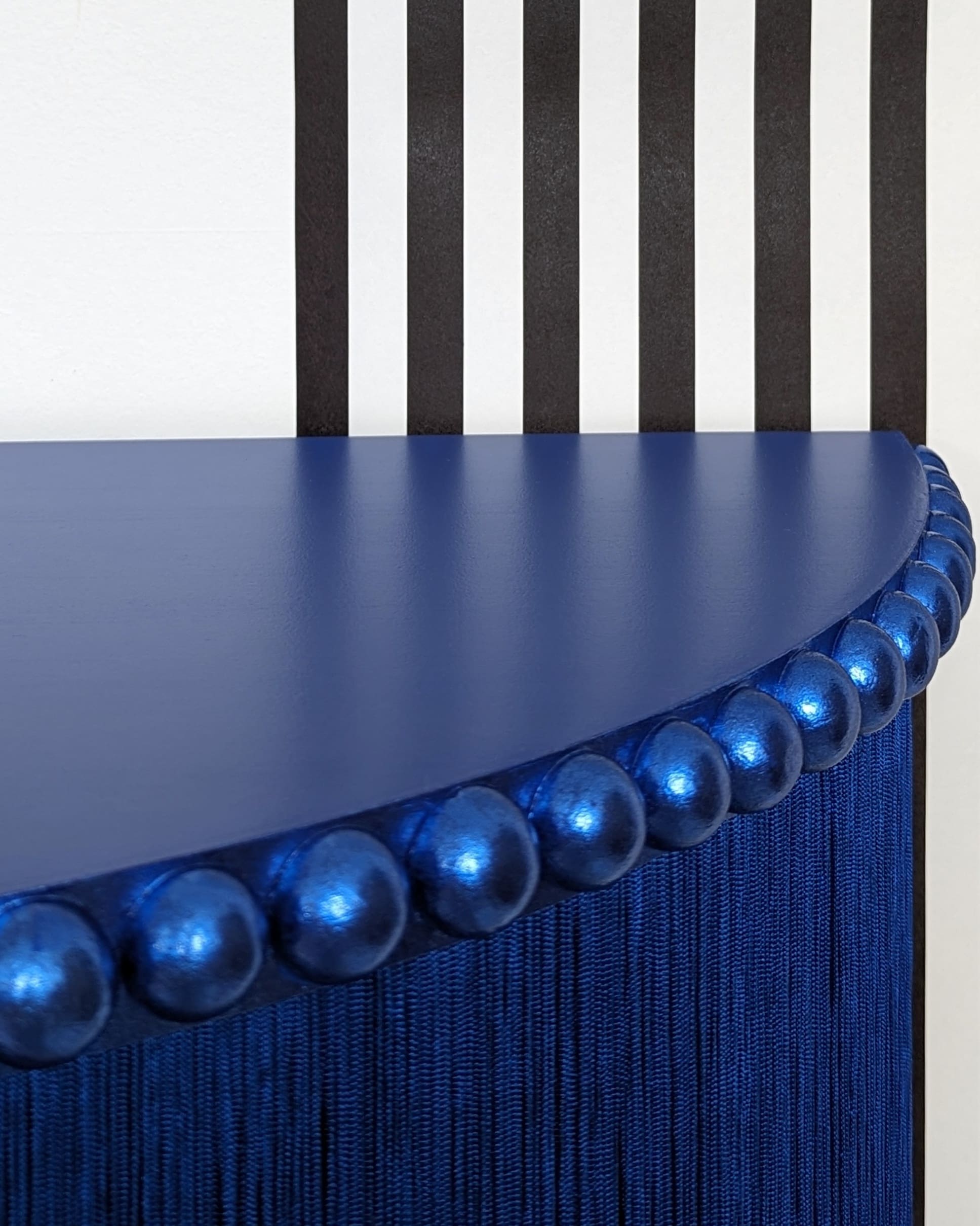 Blue half moon table top with metallic blue trim