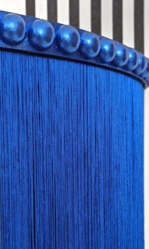 Close up of blue gilded bobbin trim and fringing