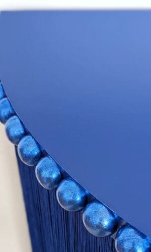 Blue console table top with close up of gilded bobbin trim