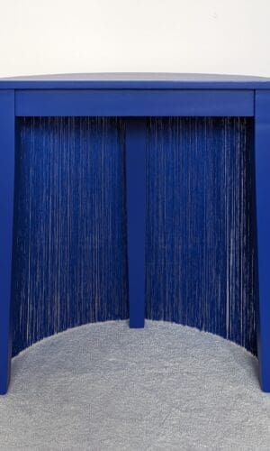 Blue fringed semi circle console table back view