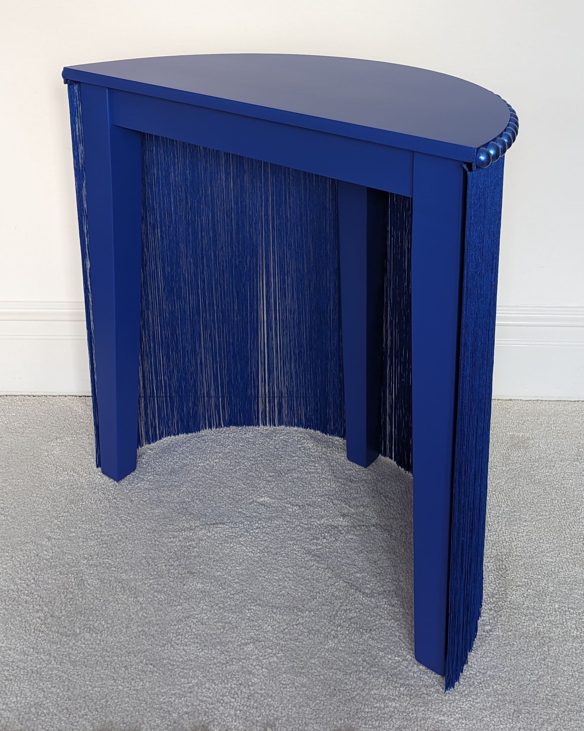 Blue console table with fringing