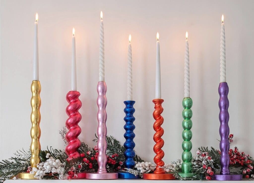 Gilded Candlesticks on a mantlepiece with Christmas garland