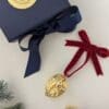 Gold walnut tee decorations with a navy gift box