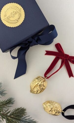 Gold walnut tee decorations with a navy gift box