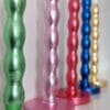 Colourful, luxury, sustainable candlesticks gilded in green, pink, red, blue and golden silver leaf