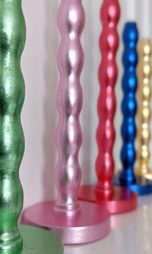 Colourful, luxury, sustainable candlesticks gilded in green, pink, red, blue and golden silver leaf