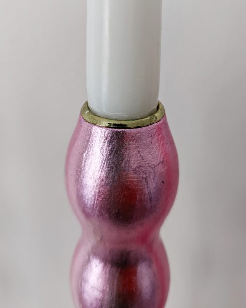Top of artisan candlestick gilded in genuine candy pink dyed silver leaf handcarfted from reclaimed table legs
