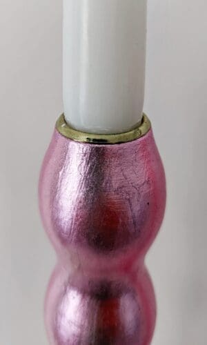 Top of artisan candlestick gilded in genuine candy pink dyed silver leaf handcarfted from reclaimed table legs