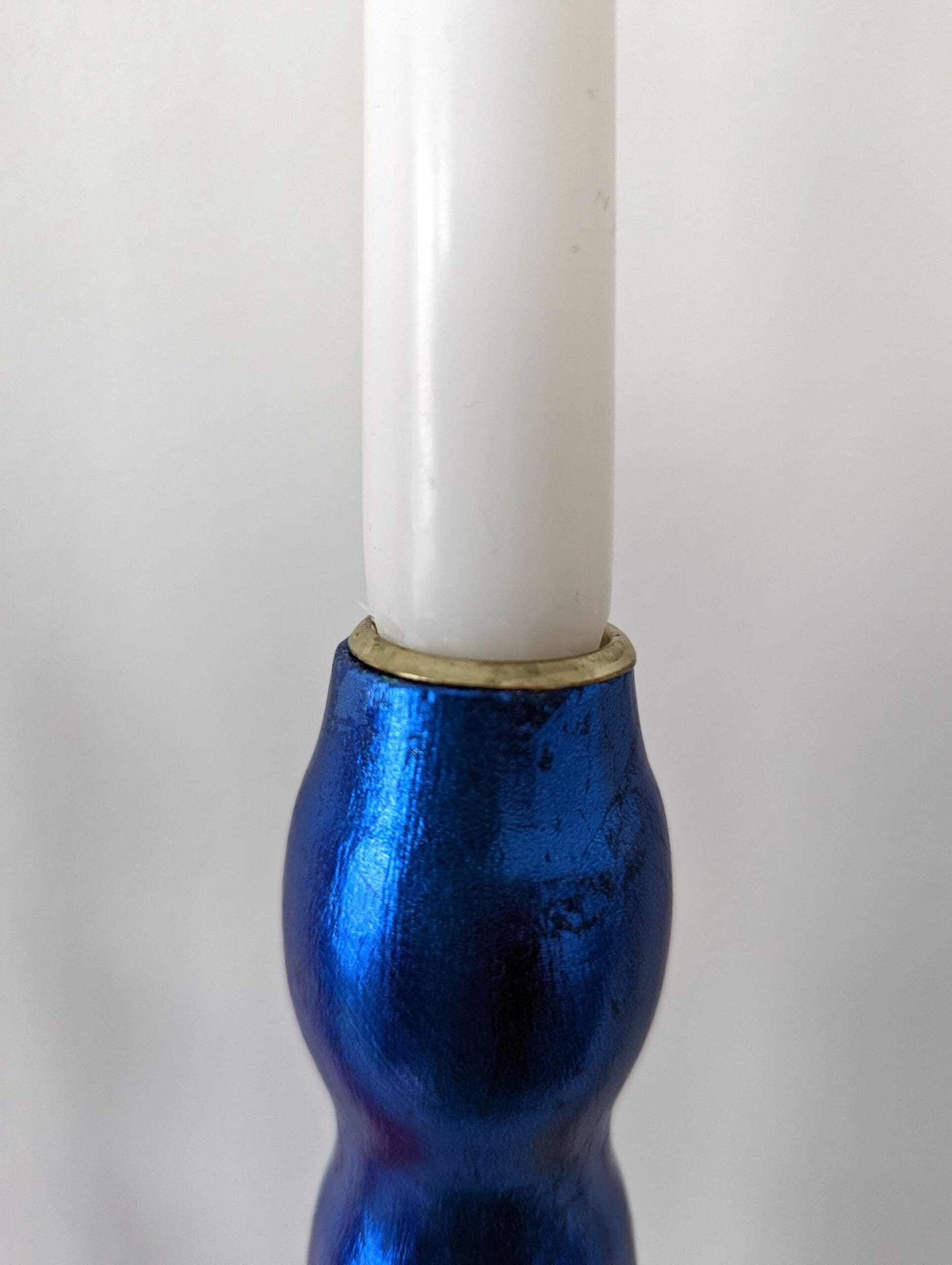 Top of artisan candlestick gilded in genuine red dyed silver leaf handcarfted from reclaimed table legs