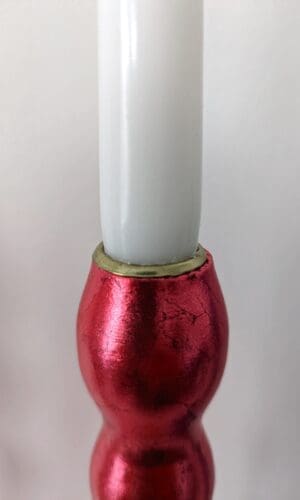 Top of artisan candlestick gilded in genuine red dyed silver leaf handcarfted from reclaimed table legs