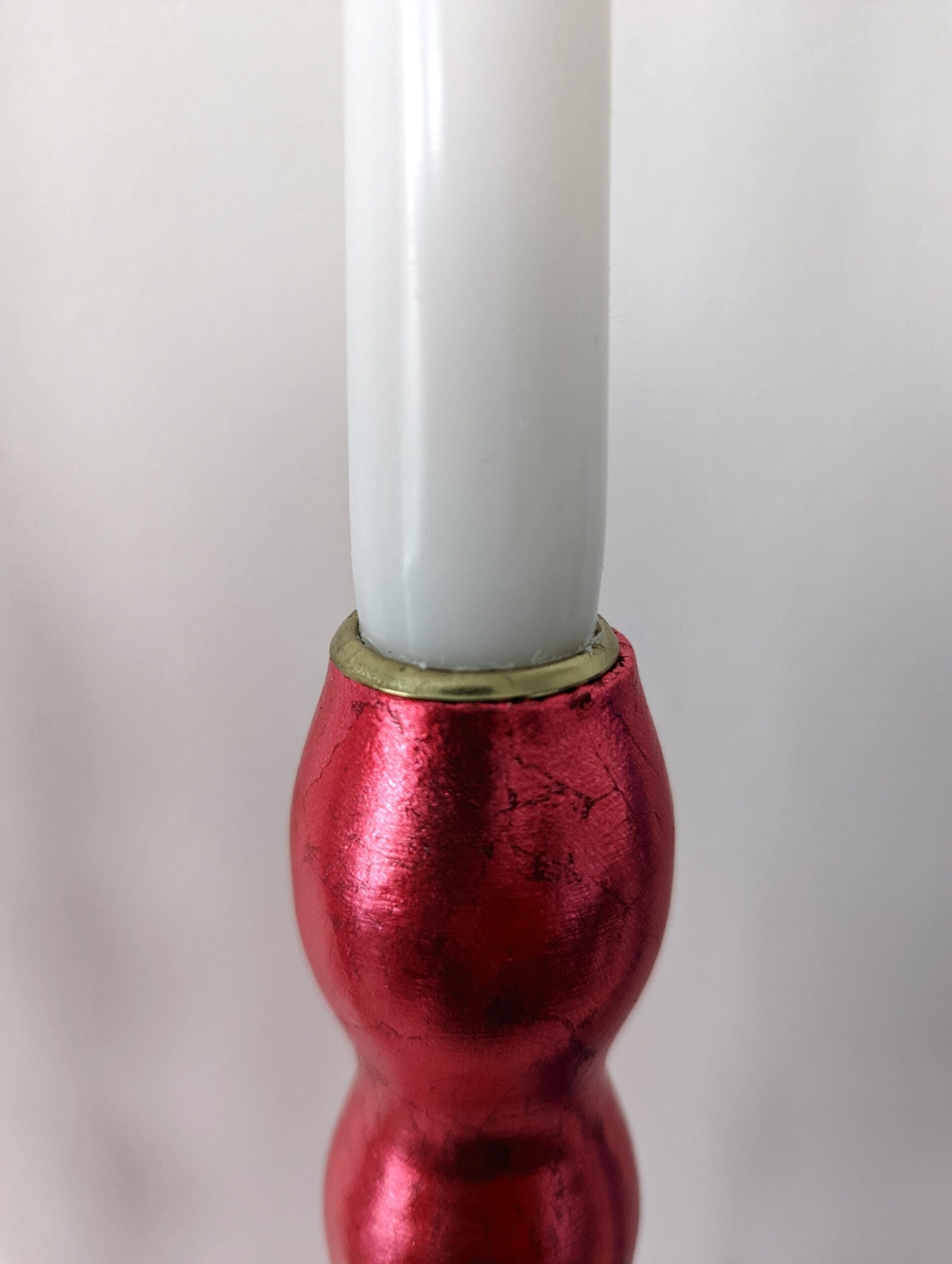 Top of artisan candlestick gilded in genuine red dyed silver leaf handcarfted from reclaimed table legs