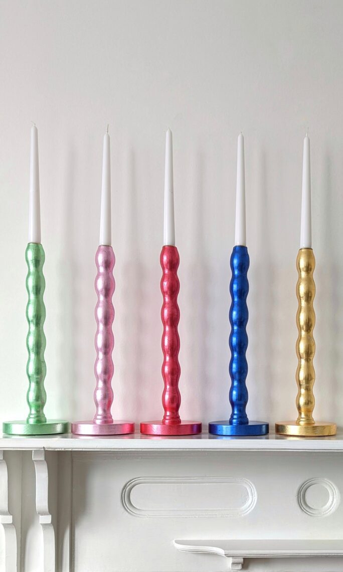 Colourful handmade candlesticks gilded in green, pink, red, blue and golden silver leaf