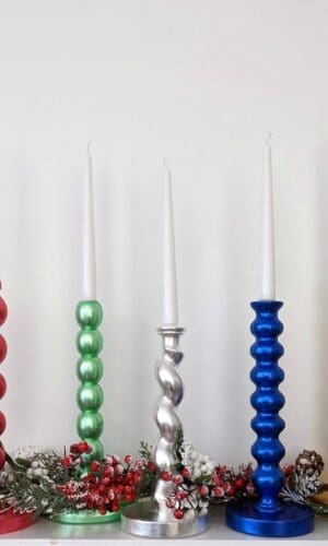 Metallic candlesticks made from reclaimed table legs in a variety of colours