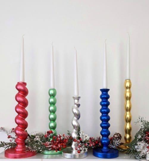 Metallic candlesticks made from reclaimed table legs in a variety of colours