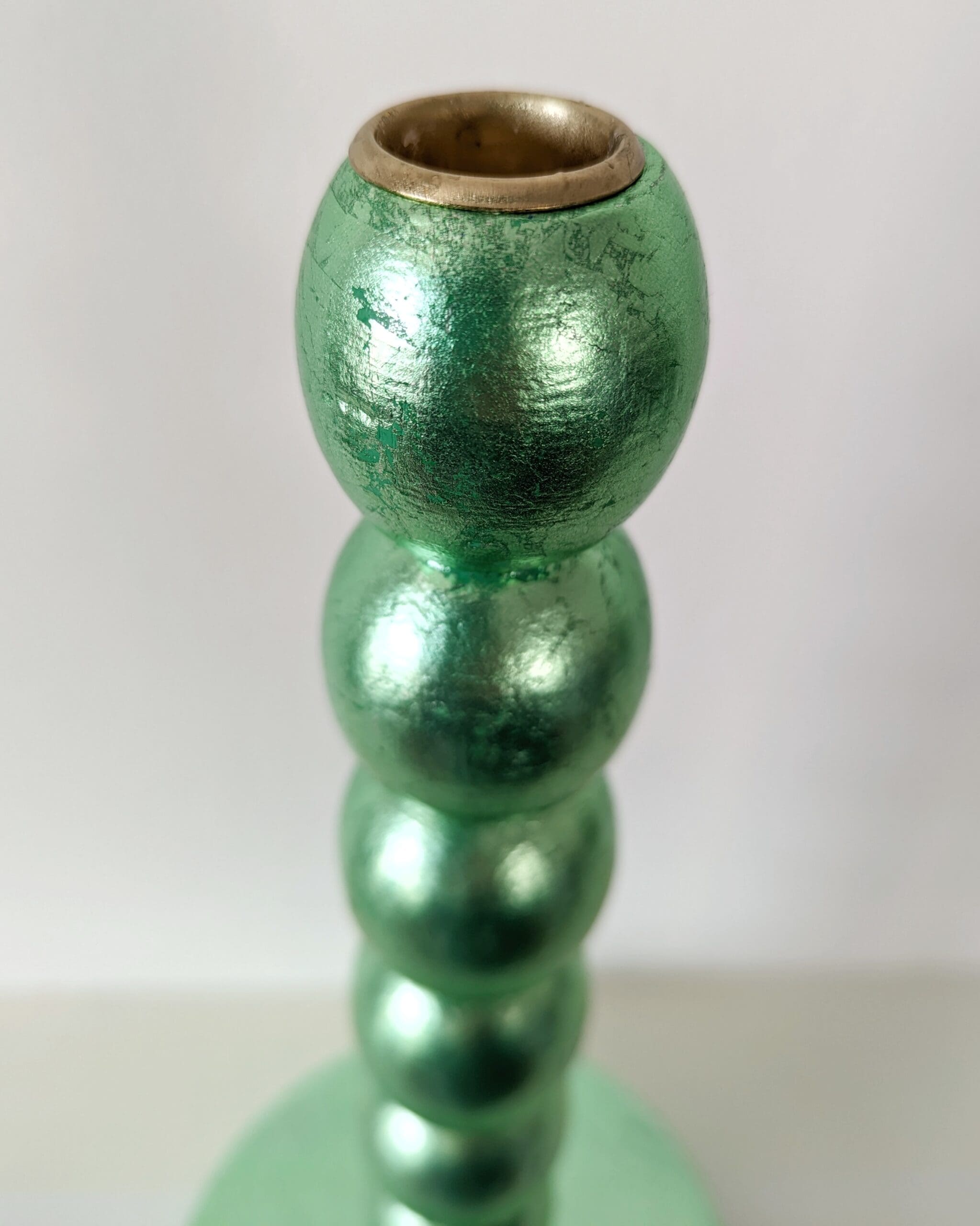 Top view of metallic green handcrafted candlestick