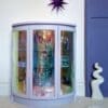Lilac drinks cabinet with iridescent curved glass doors