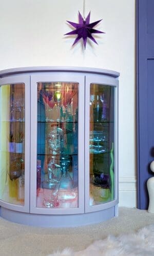 Lilac drinks cabinet with iridescent curved glass doors
