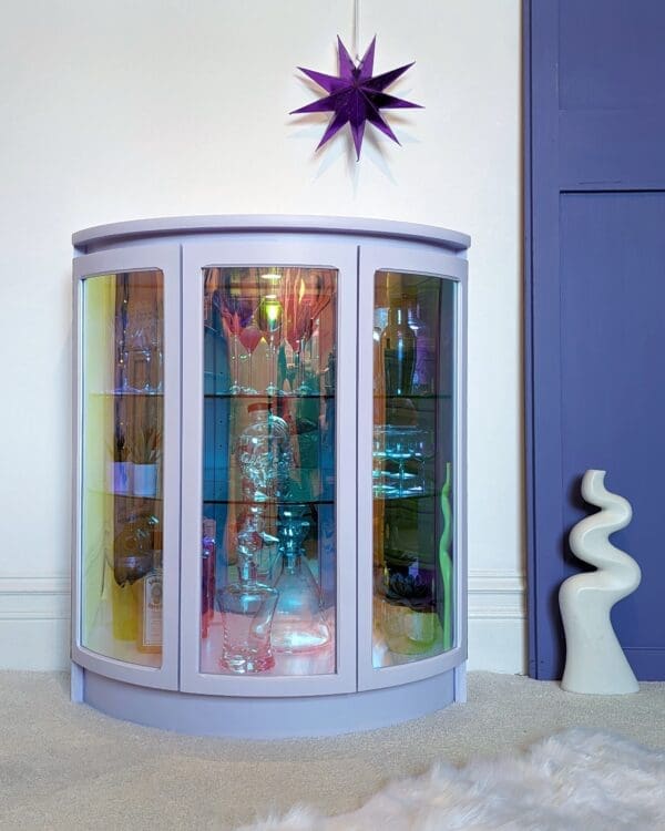 Lilac drinks cabinet with iridescent curved glass doors