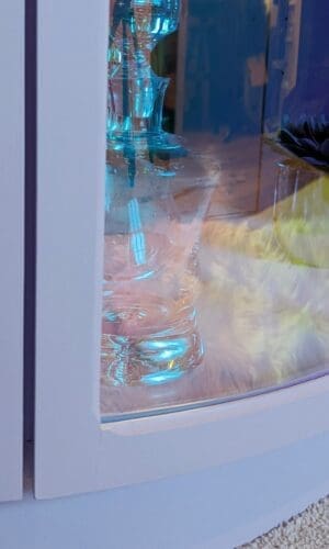 Close up of corner of iridescent curved glass door