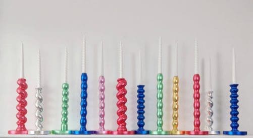 Multi-coloured gilded candlesticks made of reclaimed table legs