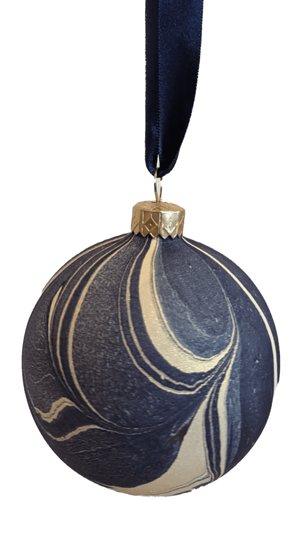 Navy blue and gold luxury marbled Christmas bauble on dark blue satin ribbon