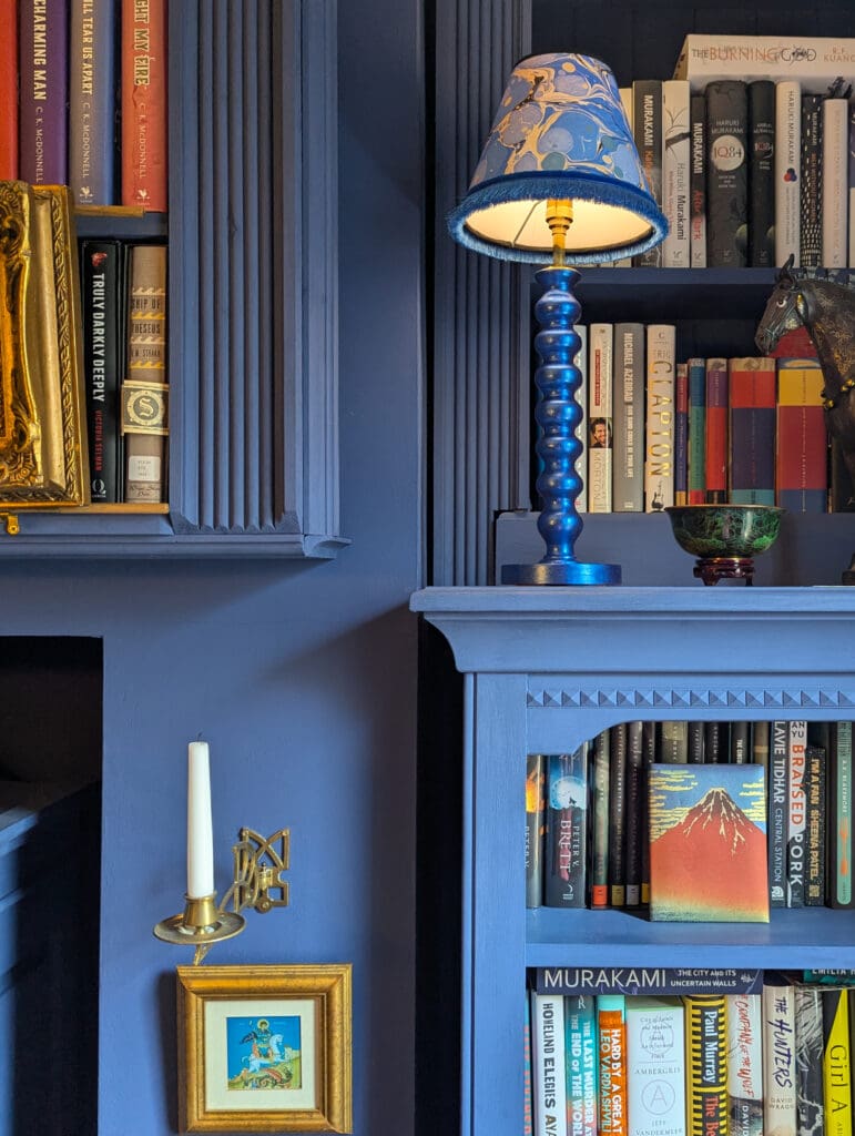 Blue cordless lamp on shelf in blue library