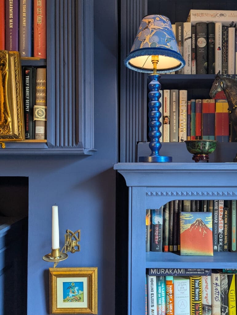 Blue cordless lamp on shelf in blue library