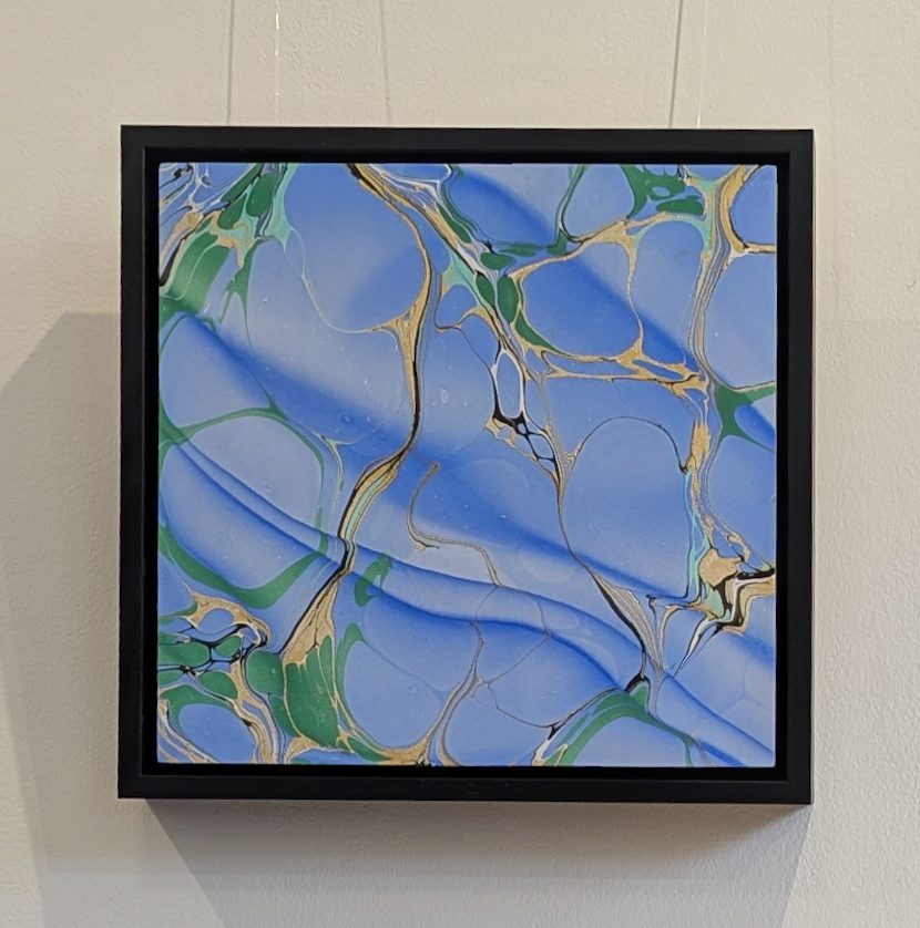blue marbled artwork in black floating frame
