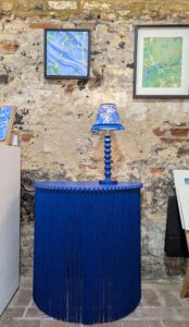 Blue fringed demi-lune console table