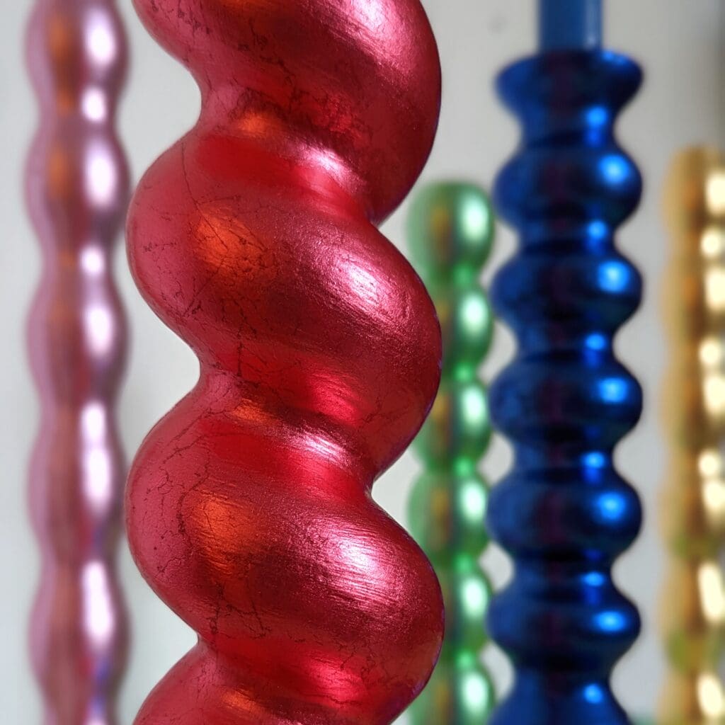 close up of multi coloured gilded candlesticks