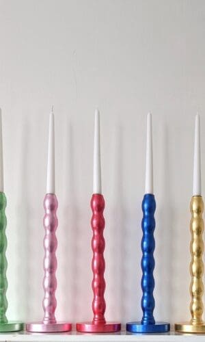 Colourful, luxury, sustainable candlesticks gilded in green, pink, red, blue and golden silver leaf