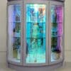 Iridescent glass drinks cabinet glowing in low light