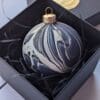 Navy and gold marbled Christmas bauble in black gift box