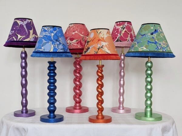 Collection of colourful table lamps made from reclaimed table legs gilded in coloured silver leaf with matching handmade marbled shades