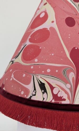 close up of handmade red and gold marbled paper lampshade