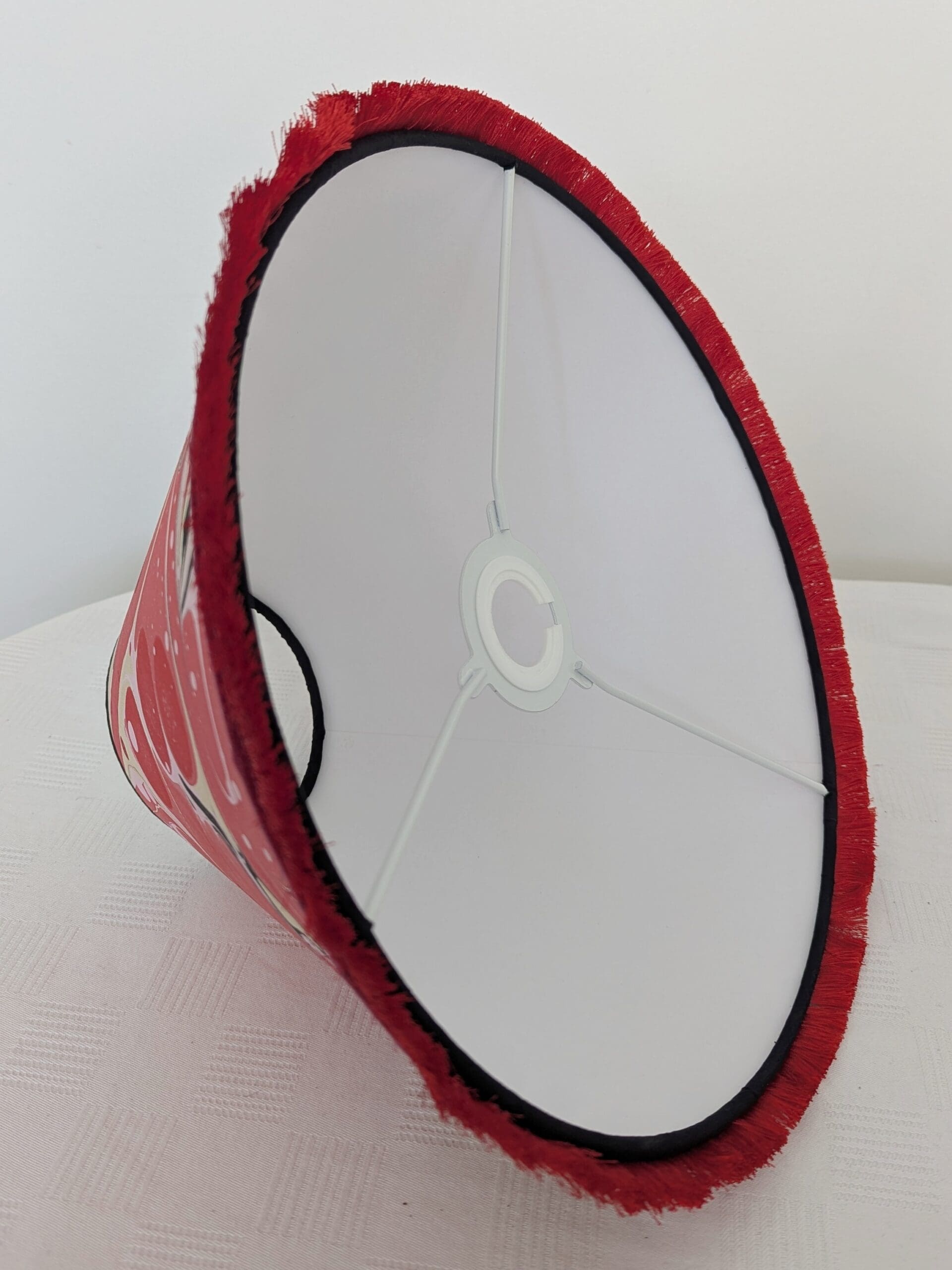 Inside view of red marbled paper lampshade showing sustainable cardboard lining
