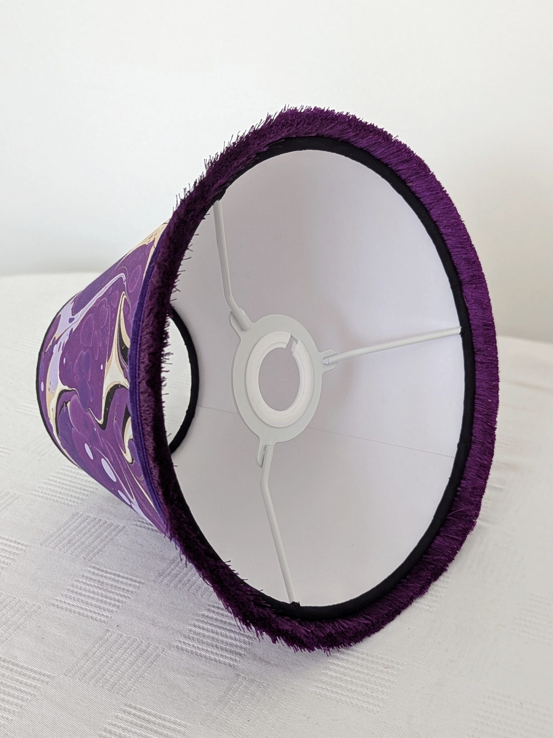 inside view of purple marbled lampshade showing white cardboard lining