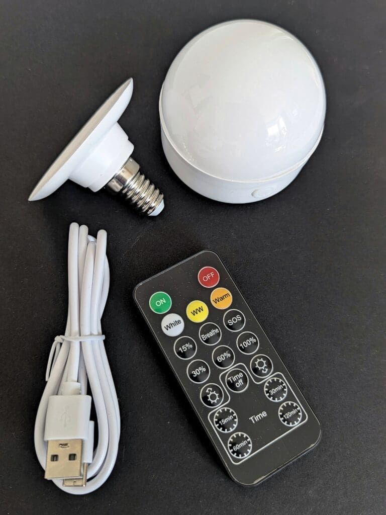PXL_20250516_154347803 Cordless rechargeable LED lightbulb with charging cable and remote control