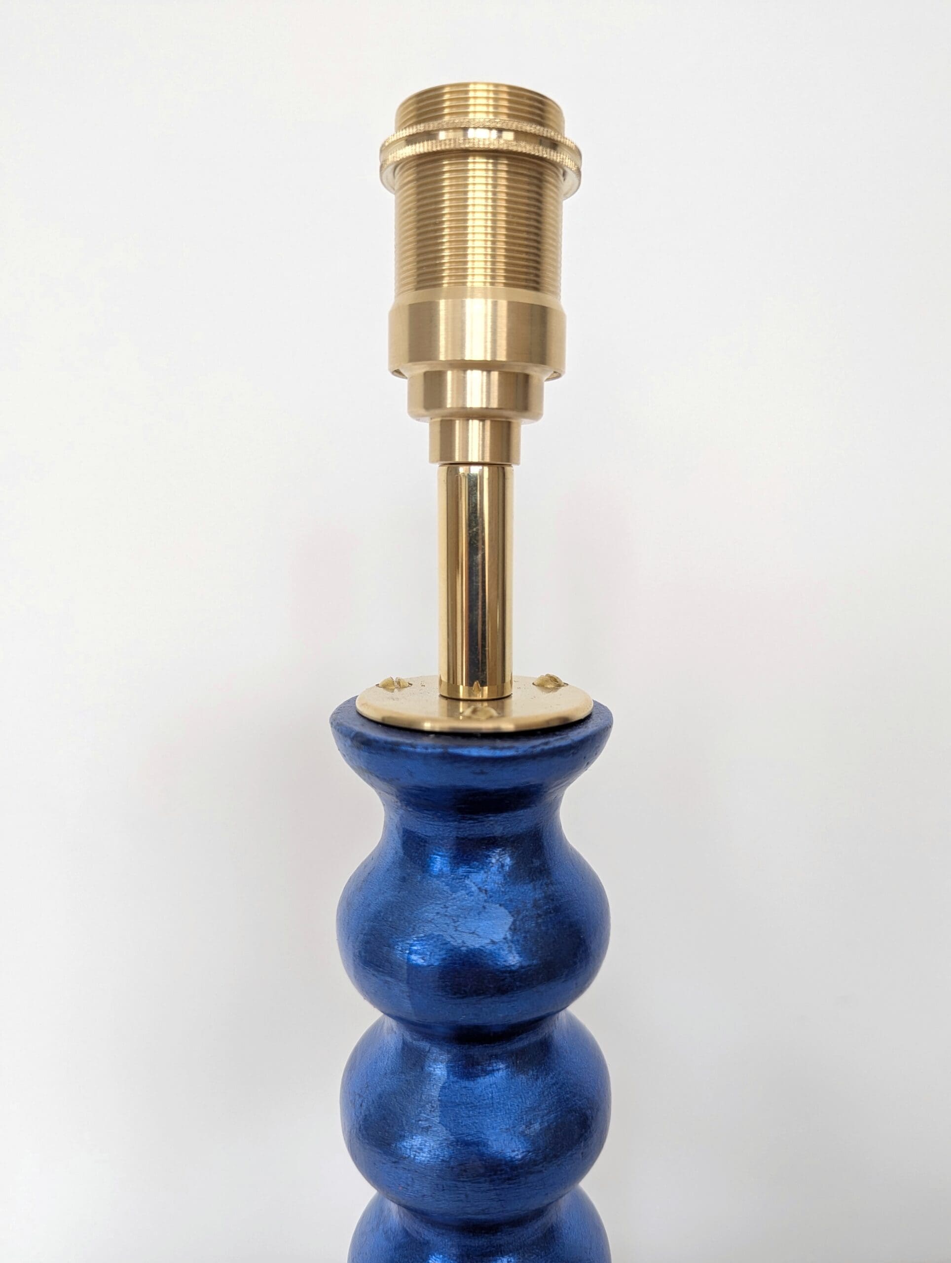 detail of brass bulb holder on blue cordless lamp