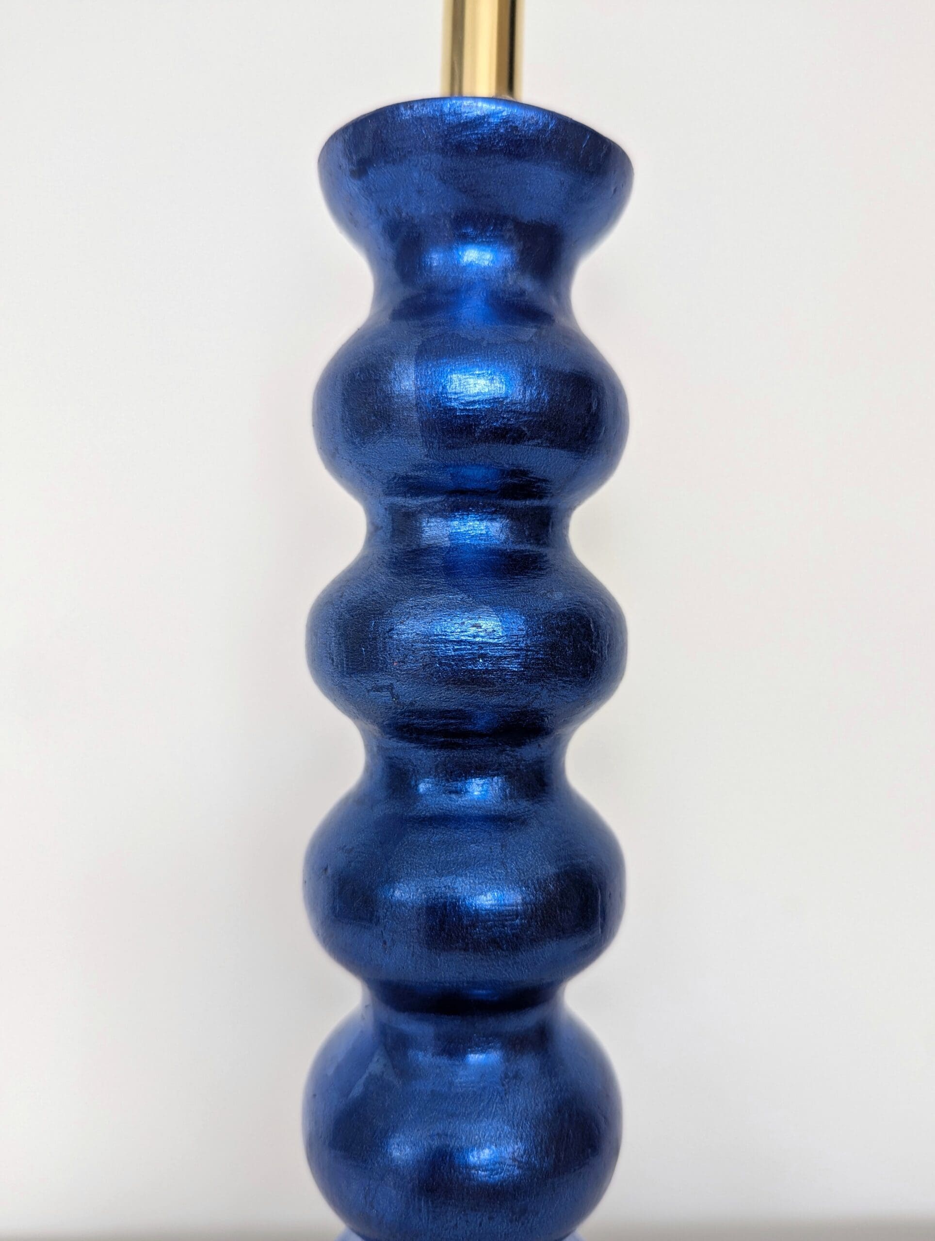 close up of cordless lamps made from reclaime bobbin chair leg and gilded in blue silver leaf