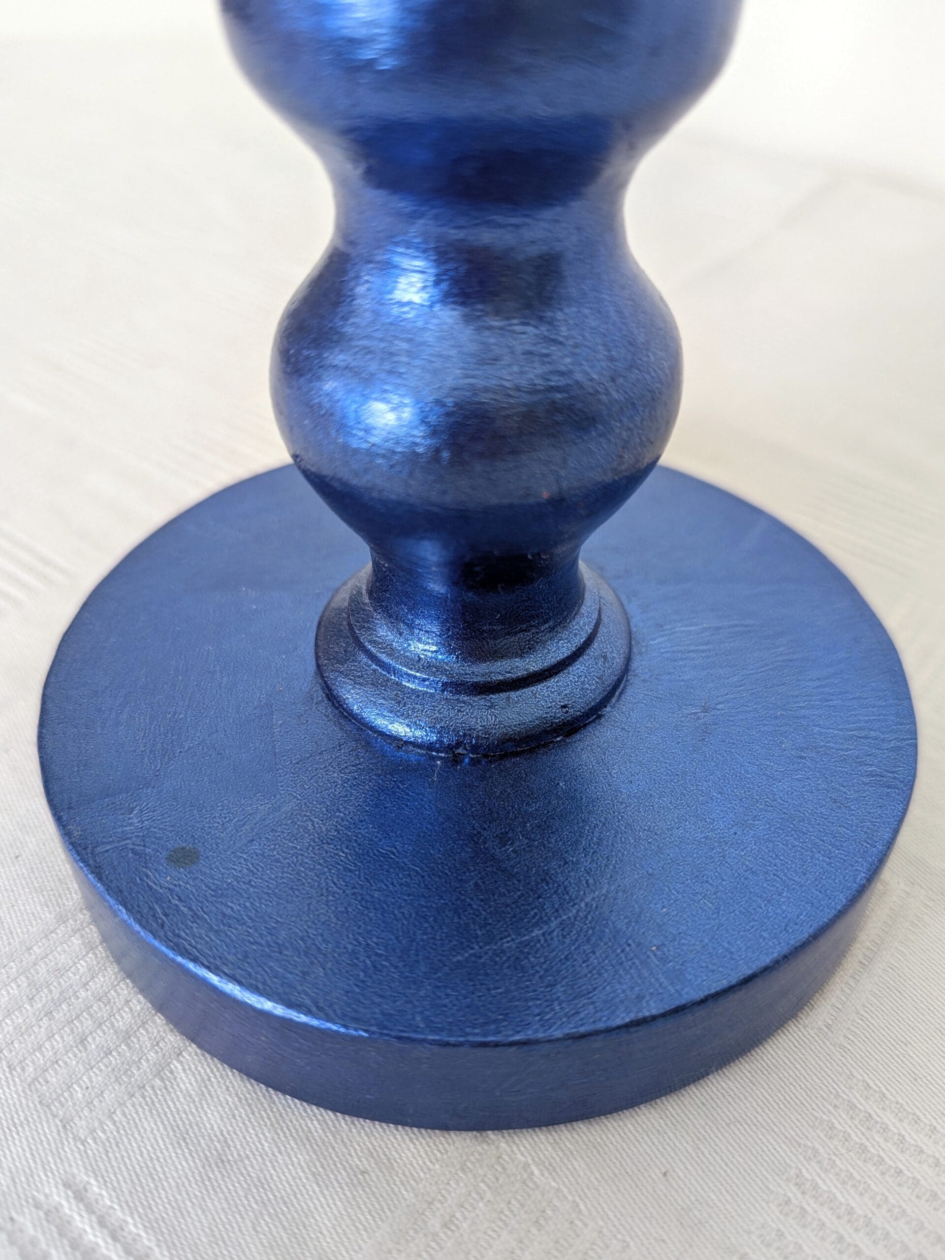 close up of base of blue gilded corless lamp made from reclaimed bobbin chair leg