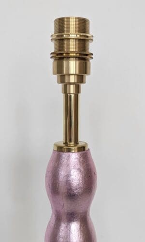 close up of brass bulb holder on pale pink gilded cordless lamp