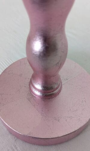 close up of base of pink cordless lamp made from reclaimed wavy chair leg